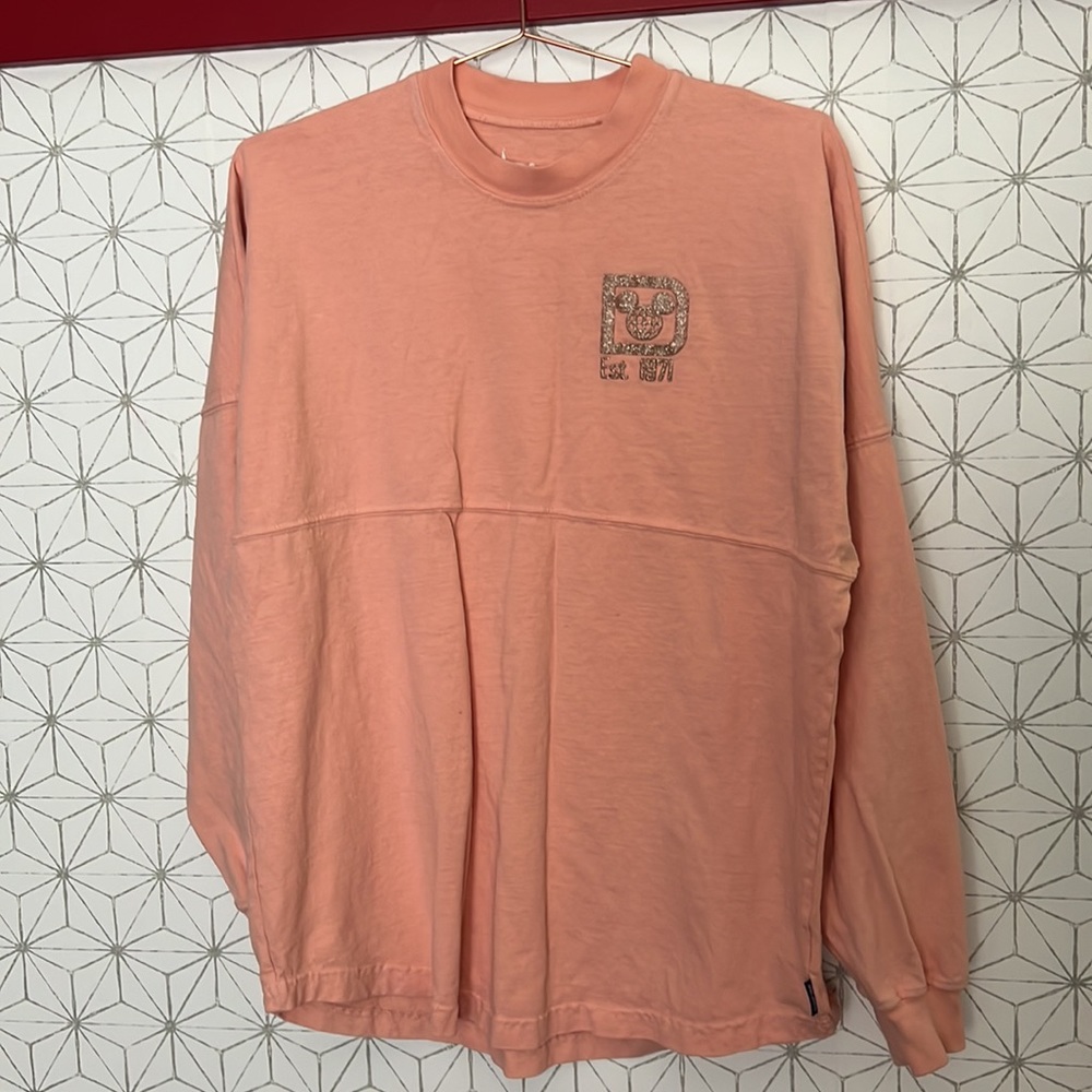 Disney world spirit jersey pinkish peach color with gold lettering size medium